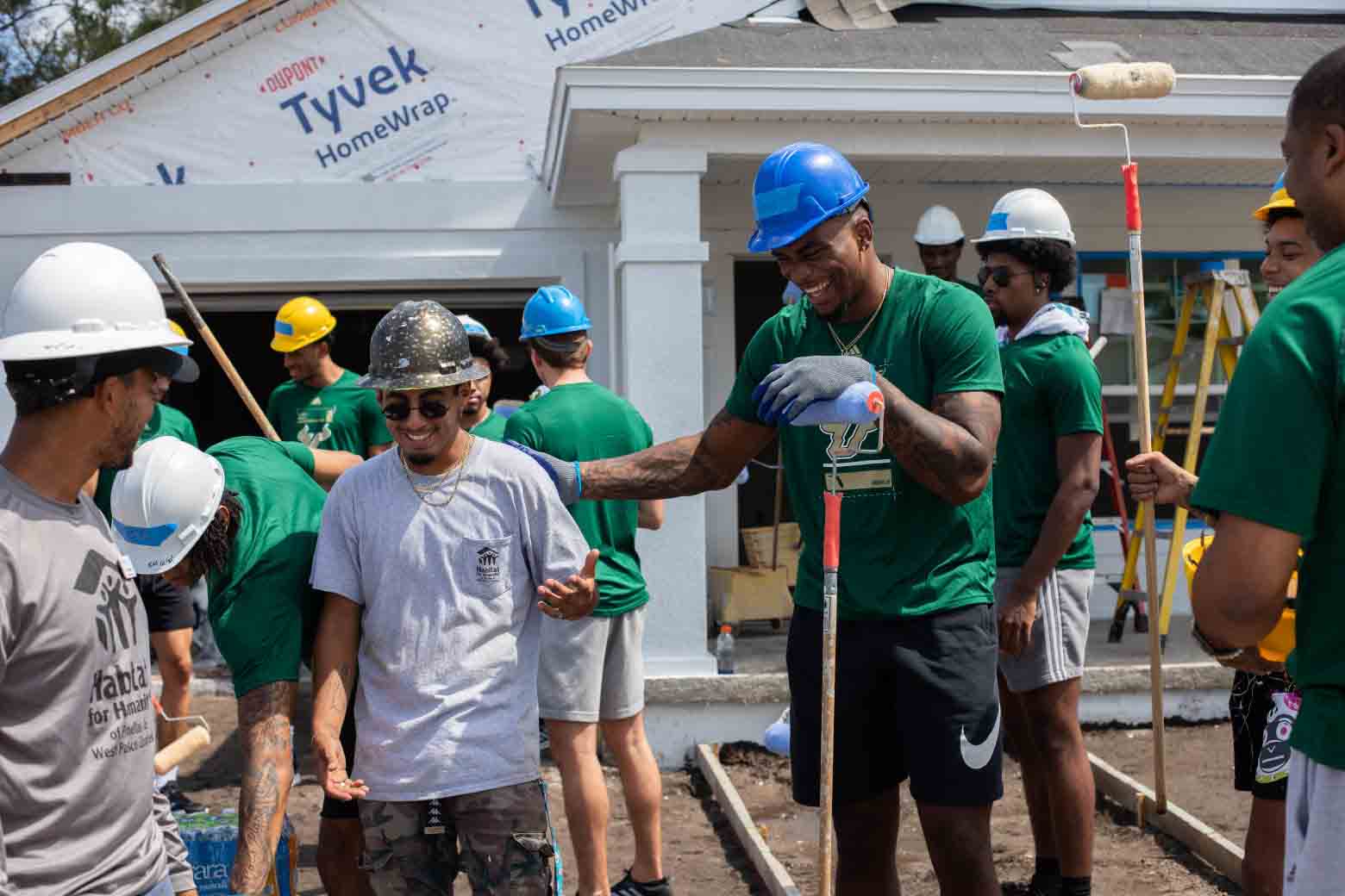 USF football and basketball teams give back with Habitat for Humanity